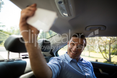 Man taking selfie while sitting in car
