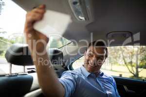 Man taking selfie while sitting in car