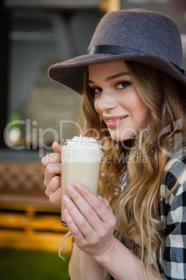 Portrait of young woman drinking cold coffee