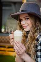 Portrait of young woman drinking cold coffee