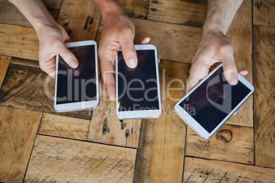Close up of friends holding mobile phone on table