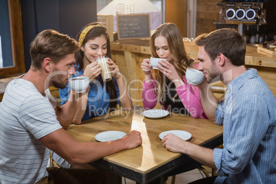 Friends having coffee at table