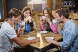 Friends having coffee at table