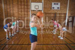 High school girl about to take a penalty shot while playing basketball in the court