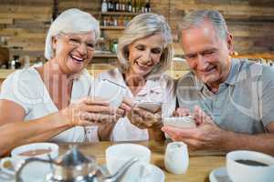 Group of senior friends using mobile phones