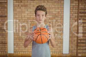 Determined boy holding a basketball