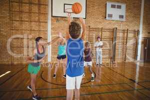 Determined high school kids playing basketball