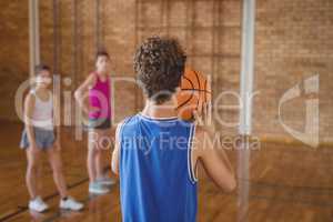 High school boy about to take a penalty shot while playing basketball
