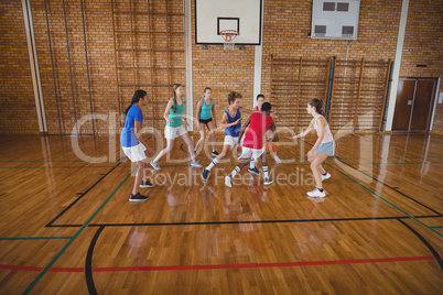 High school kids playing basketball in the court