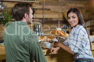 Couple sitting at counter in cafÃ?Â©
