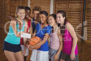 Happy high school team taking a selfie with mobile phone