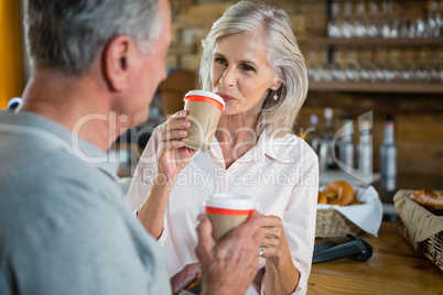 Senior couple interacting with each other while having coffee