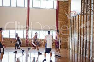 Basketball players playing in the court