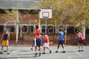 Basketball players practicing in basketball court