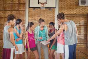 Female coach mentoring high school kids