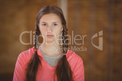 High school girl standing in basketball court