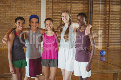 High school kids standing together in basketball court