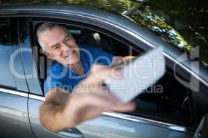 Senior man taking selfie while sitting in car