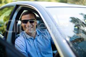 Man wearing sunglasses while driving car