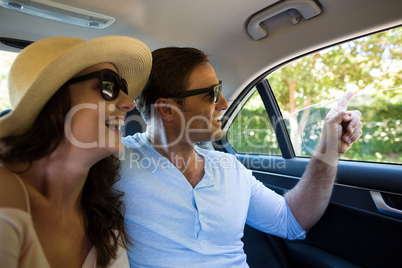 Happy couple traveling in car