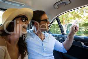 Happy couple traveling in car