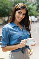 Portrait of woman holding coffee cup