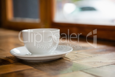 Close up of cup and saucer on wooden table