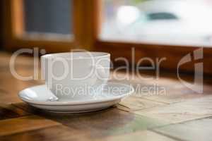 Close up of cup and saucer on wooden table