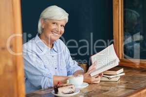 Portrait of smiling senior woman holding book