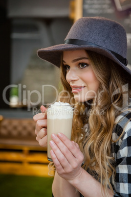 Close of young woman drinking cold coffee