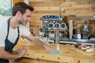 Waiter cleaning counter worktop