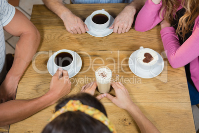 Friends having coffee at table