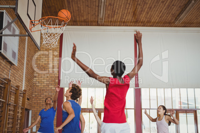Determined high school kids playing basketball
