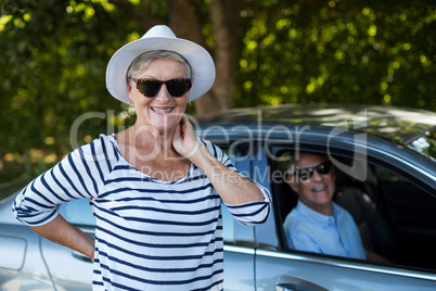 Senior woman with man sitting in car