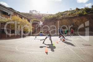 Basketball players practicing dribbling drill