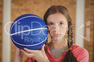 Determined girl holding a basketball