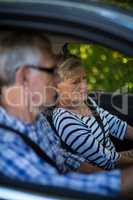 Senior woman and man in car