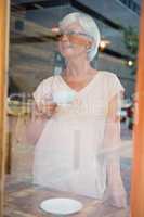 Thoughtful senior woman having coffee