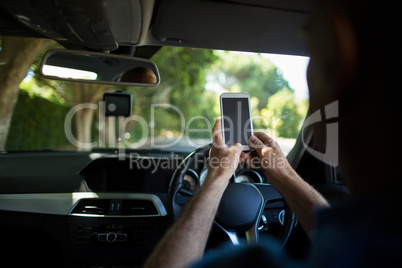 Man using mobile phone in car