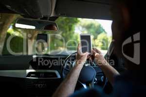 Man using mobile phone in car