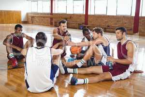 Basketball players interacting while relaxing