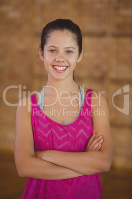 High school girl smiling while standing in basketball court