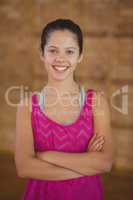 High school girl smiling while standing in basketball court