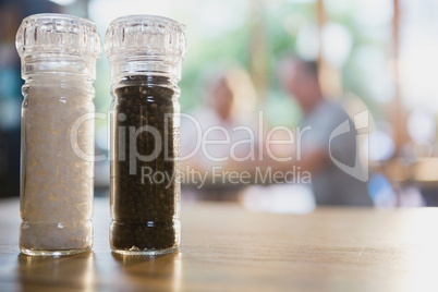 Salt and black pepper shakers on a table