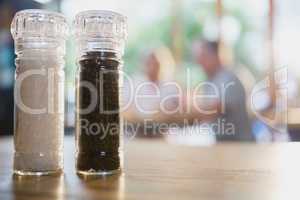 Salt and black pepper shakers on a table