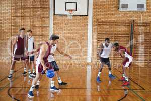 Basketball players playing in the court