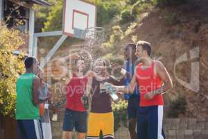 Basketball players celebrating by splashing water on each other