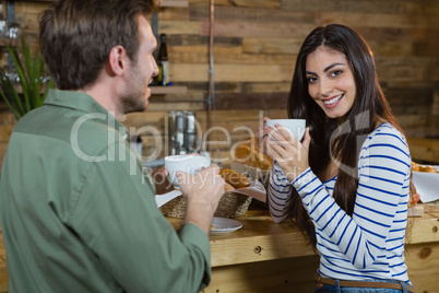 Portrait of woman having coffee at counter