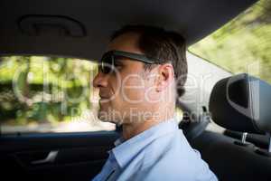 Man sitting on back seat in car