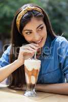 Happy woman drinking cold coffee